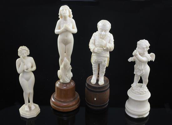 A late 19th century German carved ivory figure standing on a barrel, largest 6.5in. incl. wood plinth